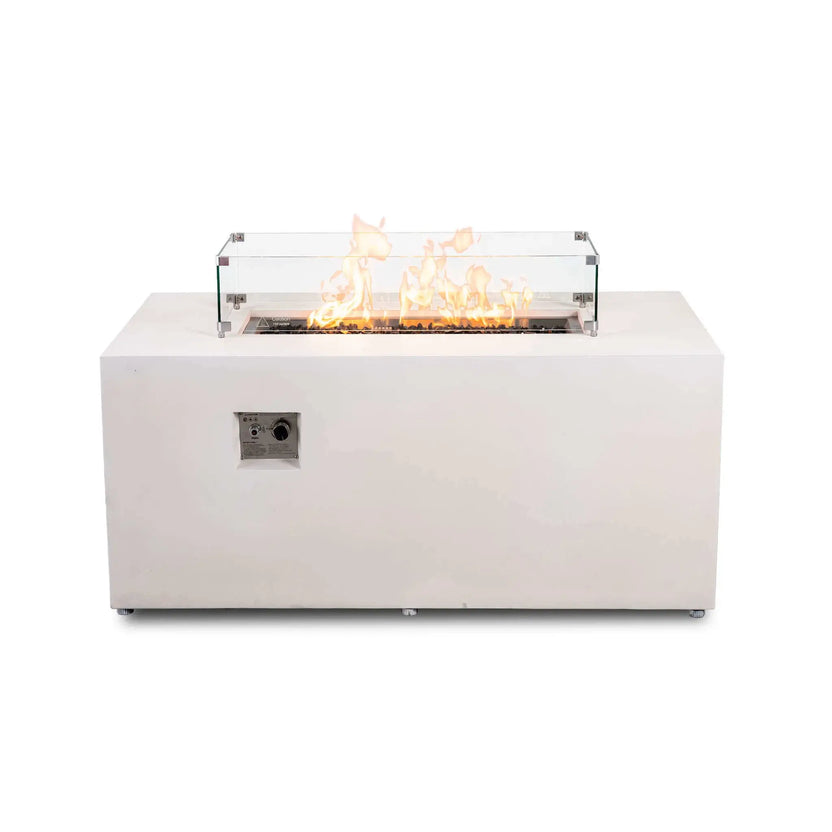 White Flame Havens Refuge Series 56 x 30 x 24-inch rectangular propane gas fire pit shown from the front with flames burning over tempered black fire glass, surrounded by a clear tempered glass wind guard with metal corner brackets and raised feet; recessed ignition controls are visible on the front.
