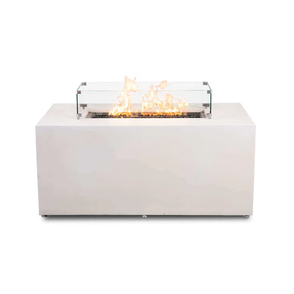 Straight front view of the Flame Havens Refuge Series 56 x 30 x 24-inch rectangular propane gas fire pit in white GFRC concrete, shown burning over tempered black fire glass with a clear tempered glass wind guard, polished metal corner brackets, raised feet, a wide tabletop ledge, and discreet adjustable feet.