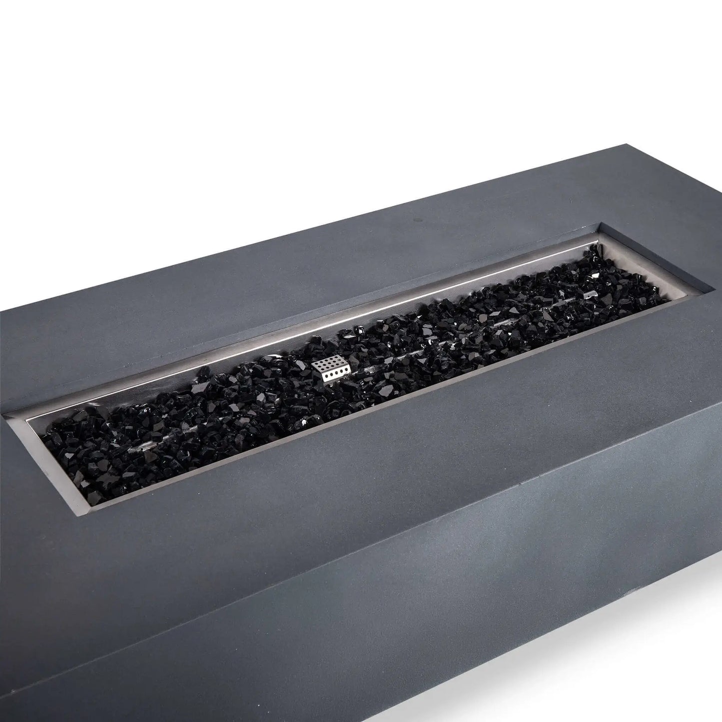 Close angled view of the Flame Havens Refuge Series 68 x 30 x 15-inch rectangular natural gas fire pit in natural gray GFRC concrete. The recessed stainless steel burner pan is filled with reflective black fire glass, with the ignition cage and linear burner components visible against a white background.