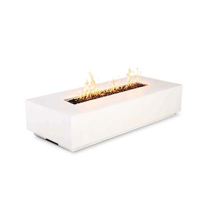 Angled view of the Flame Havens Refuge Series 68 x 30 x 15-inch white GFRC rectangular natural gas fire pit burning on a white background. A continuous row of golden flames rises from tempered black fire glass in the linear burner opening, with no control panel visible on the front face.