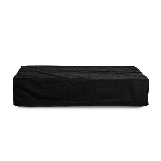 Straight-on product view of the Flame Havens Refuge Series 68 x 30 x 15-inch rectangular natural gas fire pit fully protected by a fitted black canvas fabric cover. The low-profile cover follows the fire pit’s long rectangular shape and extends to the base, shown against a clean white background.