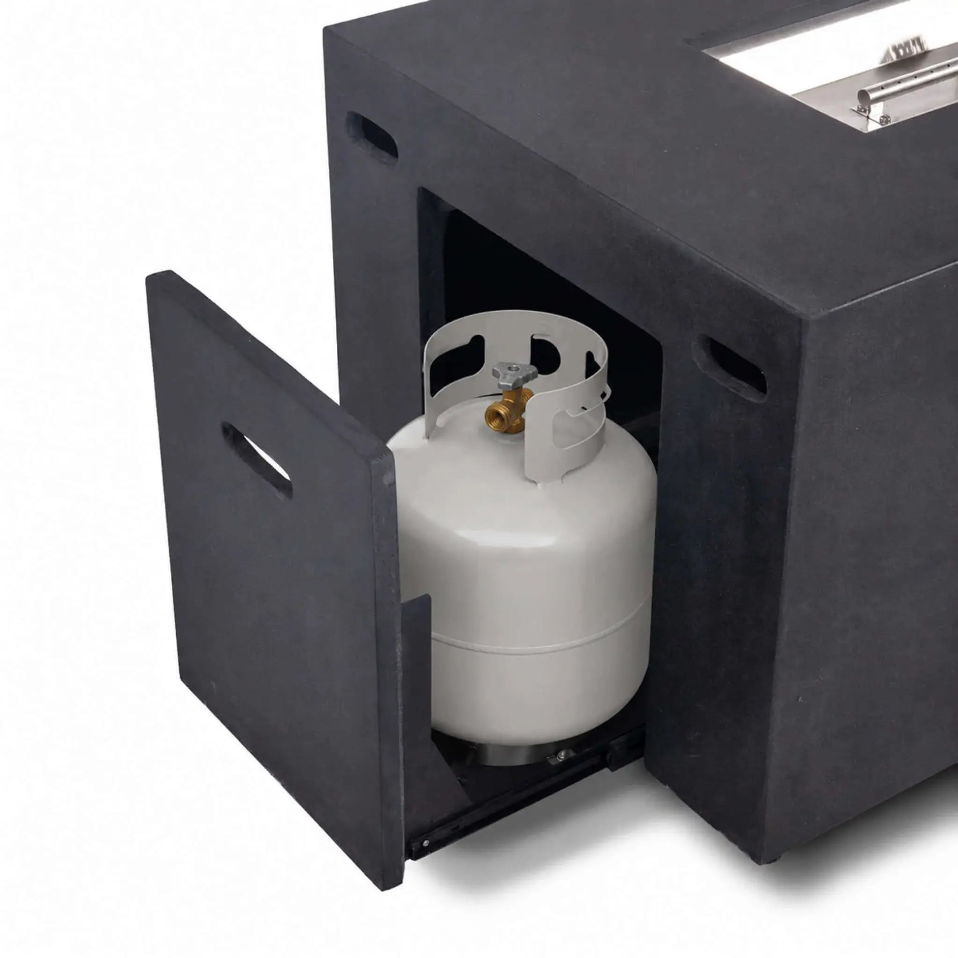 Hidden propane tank drawer pulled open on the black Flame Havens Refuge Series 68 x 30 x 24-inch rectangular GFRC concrete fire pit, revealing the enclosed propane cylinder and easy-access sliding compartment built into the short end of the fire pit.