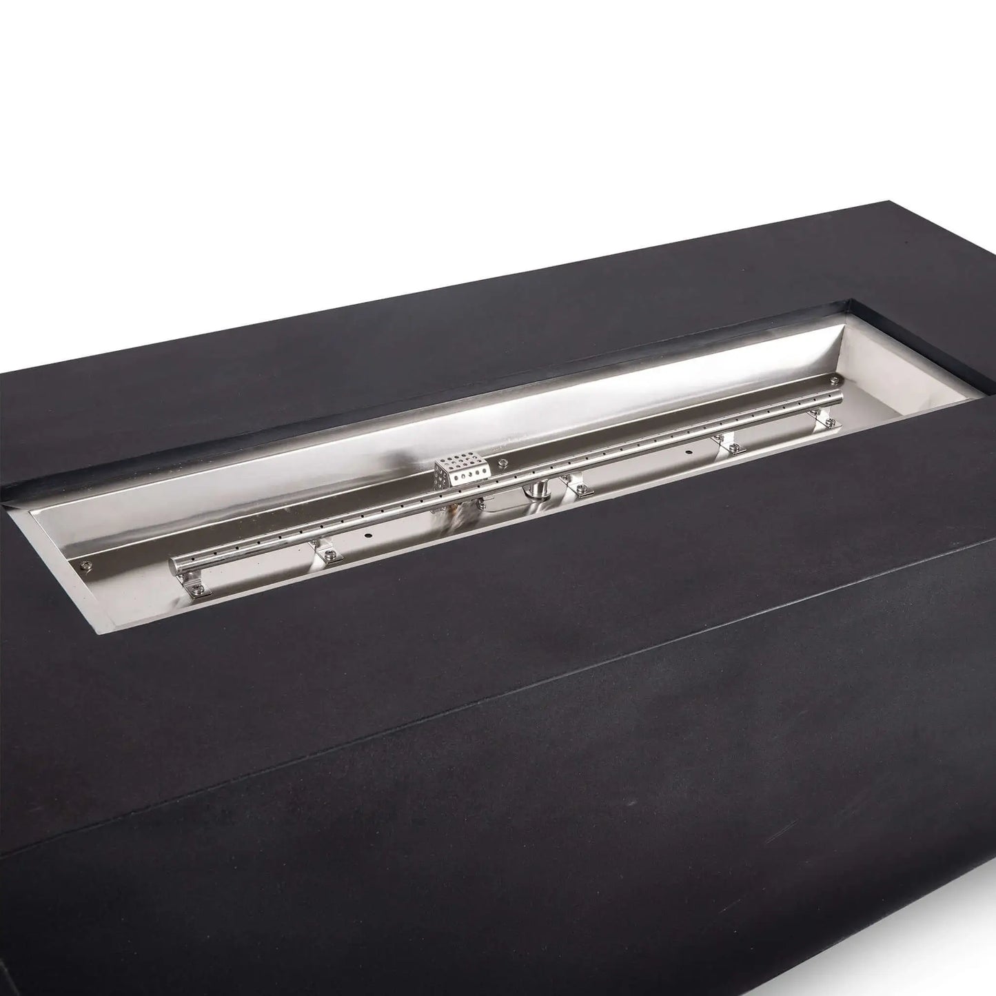 Angled close-up of the Flame Havens Refuge Series black GFRC concrete propane fire pit, showing the full stainless steel burner pan, linear burner tube, mounting brackets, gas fittings, and protective ignition cage within the 68 x 30 x 24-inch rectangular design.