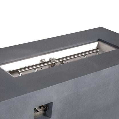 Angled close-up of the Flame Havens Refuge Series 68 x 30 x 24-inch gray propane fire pit, highlighting the polished stainless steel linear burner and pan, perforated ignition cage, mounting hardware, and recessed CSA ignition control panel.