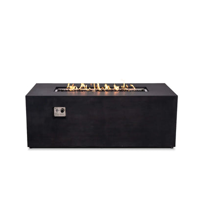 Straight-on product view of the Flame Havens Refuge Series 68 x 30 x 24-inch rectangular black GFRC concrete propane fire pit with the flame turned on. A long row of natural-looking flames rises above reflective tempered black fire glass, and the recessed ignition and flame control panel is visible on the front.