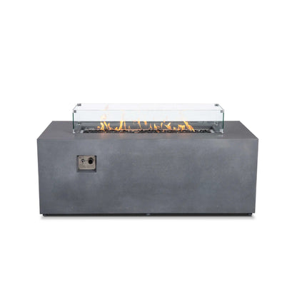 Straight front view of the Flame Havens Refuge Series 68 x 30 x 24-inch rectangular gray propane fire pit with flames burning over tempered black fire glass. A clear glass wind guard with stainless steel corner brackets surrounds the linear burner.