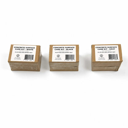 Three packaged Flame Havens Refuge Series concrete surface care kits displayed on a white background. The labeled cardboard boxes show all color-matched options: White on the left, Black in the center, and Gray on the right. Each package includes the Flame Havens logo, product number, and barcode.