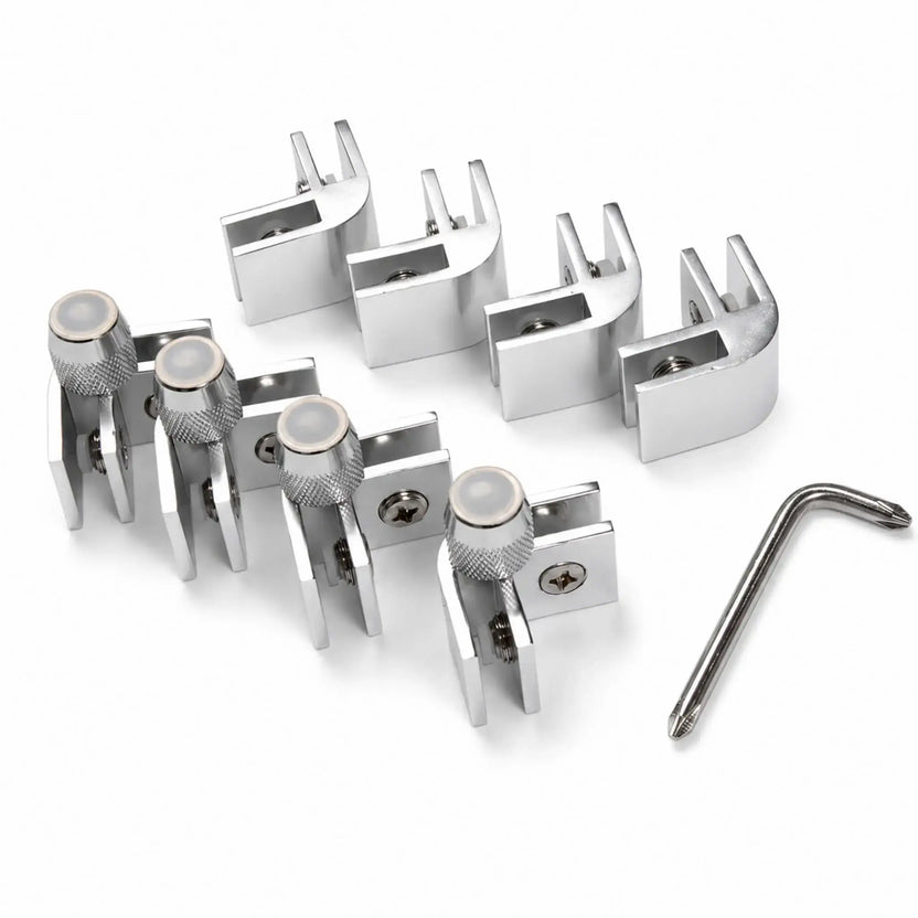 Angled view of the Flame Havens Refuge Series rectangle and square tempered glass wind guard hardware kit. The set includes polished metal corner brackets with protective glass inserts, Phillips screws, four support clamps with knurled adjustment knobs and clear feet, plus an L-shaped assembly tool.