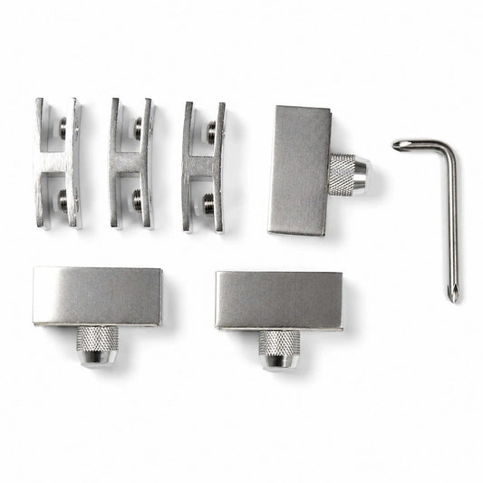 Flame Havens Refuge Series hardware kit for a round 28-inch tempered glass wind guard, displayed on a white background. The set includes three dual-slot metal glass clamps with cushioned screw contacts, three rectangular support feet with knurled adjustment knobs, and an L-shaped driver tool for installation.