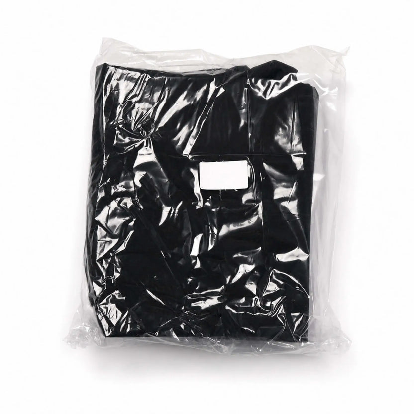 Flame Havens Refuge and Serenity Series fabric canvas cover accessory, folded and sealed inside clear protective packaging. The black cover is shown against a white background with its stitched fabric panels visible through the plastic and a blank rectangular identification label centered on the front.