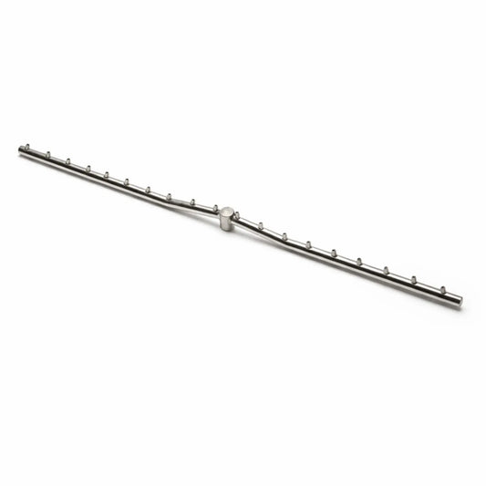 A stainless steel Torpedo T linear burner displayed on a clean white background, showing the T-shaped gas line with evenly spaced burner ports along both sides. The minimalist product shot highlights the precision design and construction of the fire pit burner component.