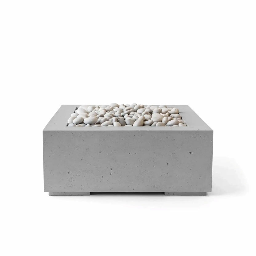 HPC Fire Hearth Products Controls Dekko GFRC Concrete Alea 32 x 32 Fire Pit in Charcoal finish accented with ivory fire stones. The contemporary square fire pit features textured GFRC concrete construction, a recessed burner tray, and a dark gray finish that contrasts beautifully with the light decorative stones, making it ideal for upscale outdoor gathering spaces and modern patio designs.