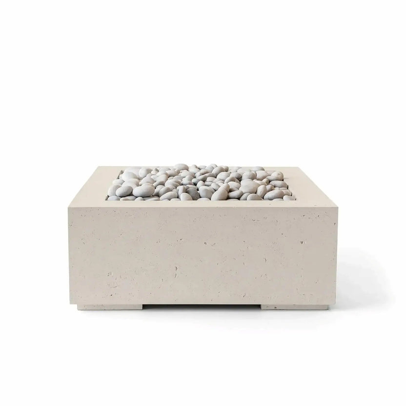 HPC Fire Hearth Products Controls Dekko GFRC Concrete Alea 32 x 32 Fire Pit in Clay finish with ivory decorative stones. This contemporary square fire pit combines a warm beige concrete tone with smooth light-colored stones, creating an elegant outdoor centerpiece featuring durable GFRC construction, a recessed burner area, and a versatile design suitable for patios and outdoor living spaces.