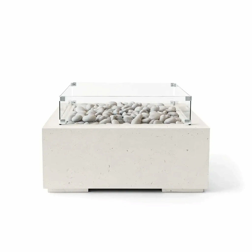 HPC Fire Hearth Products Controls Dekko GFRC Concrete Alea 32 x 32 Fire Pit in Limestone finish with ivory fire stones and a tempered glass wind guard. The square outdoor fire pit features a light limestone-colored GFRC concrete base, clean architectural lines, decorative stone media, and a contemporary low-profile design, displayed in a professional white-background product image.