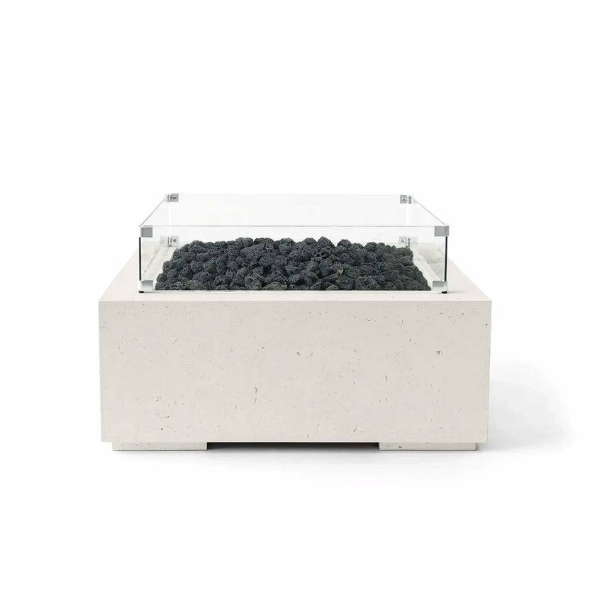 Front-facing product image of the HPC Fire Hearth Products Controls Dekko GFRC Concrete Alea 32 x 32 Fire Pit in Limestone finish, featuring black lava rock fire media and a clear tempered glass wind guard. The square GFRC concrete fire pit showcases a soft limestone-colored texture, clean contemporary lines, and a recessed burner area designed for modern outdoor patios, courtyards, and entertaining spaces.
