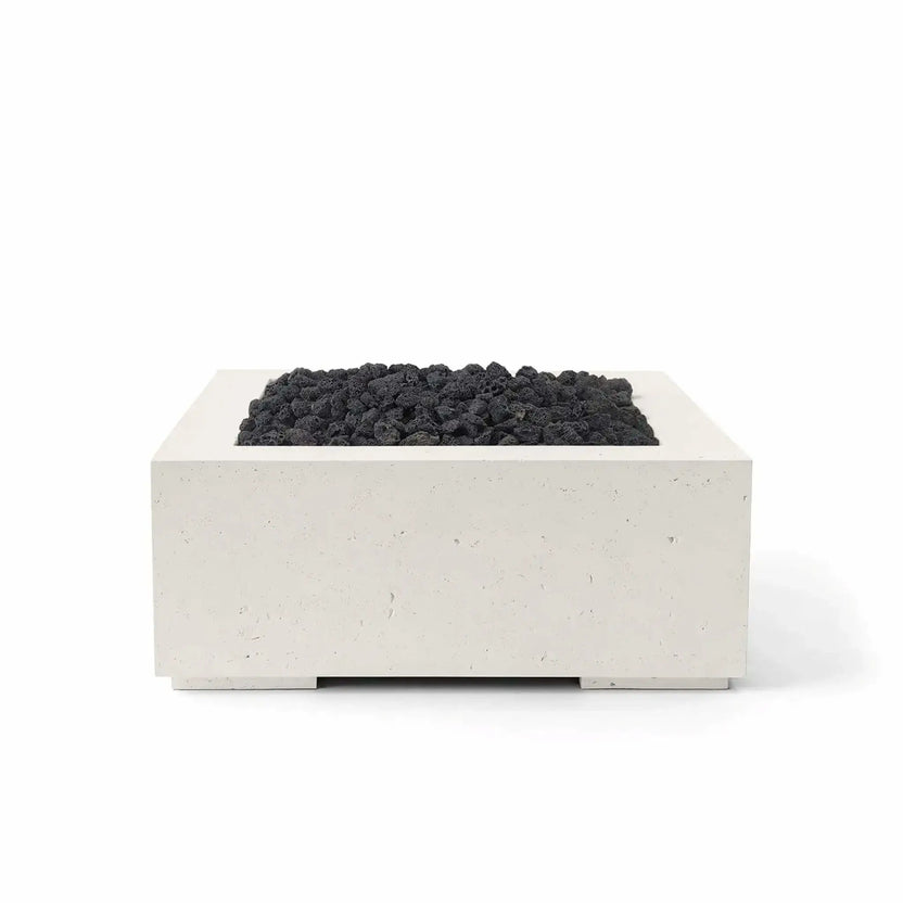 HPC Fire Hearth Products Controls Dekko GFRC Concrete Alea 32 x 32 Fire Pit featuring a Limestone finish and black lava rock media. The square GFRC concrete fire pit combines warm neutral tones with rugged volcanic rock, creating strong visual contrast. Its streamlined design, recessed burner compartment, and durable outdoor construction make the Alea fire pit ideal for modern backyard entertainment and patio environments.