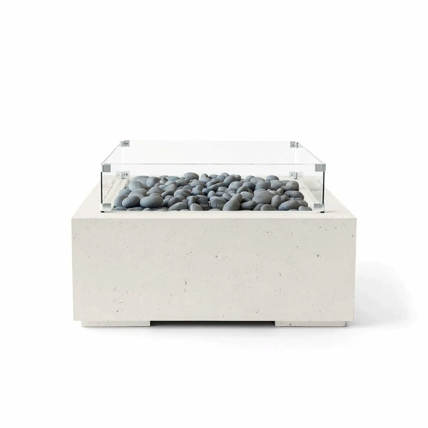 HPC Fire Hearth Products Controls Dekko GFRC Concrete Alea 32 x 32 Fire Pit in Limestone finish with smooth gray slate stone fire media and a tempered glass wind guard. Displayed from the front against a white background, this square GFRC concrete fire pit combines a light stone-inspired finish, modern architectural styling, and decorative media for a refined outdoor fire feature.