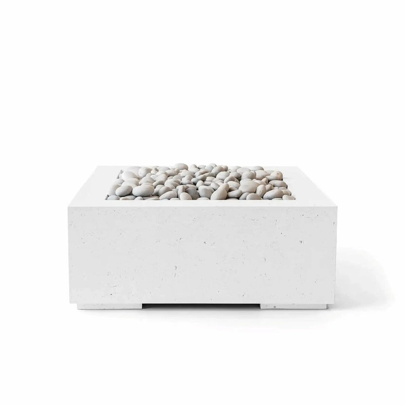 HPC Fire Hearth Products Controls Dekko GFRC Concrete Alea 32 x 32 Fire Pit in Natural finish with ivory decorative stones. The square outdoor fire pit features a light concrete appearance, smooth rounded white stones, and a recessed burner area designed for modern outdoor living. Built from durable GFRC concrete, the Alea fire pit offers a timeless minimalist aesthetic that complements patios, courtyards, and contemporary landscape designs.