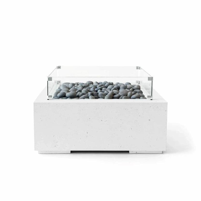 Front-facing studio image of the HPC Fire Hearth Products Controls Dekko GFRC Concrete Alea 32 x 32 Fire Pit in Natural finish with smooth gray slate stones and a tempered glass wind guard. The square GFRC concrete fire table highlights contemporary styling, subtle texture, and decorative stone media designed for upscale residential outdoor environments.