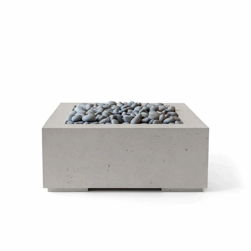 HPC Fire Hearth Products Controls Dekko GFRC Concrete Alea 32 x 32 Fire Pit in Sandstone finish with polished slate stone fire media. This contemporary square fire pit features durable glass fiber reinforced concrete construction, smooth gray decorative stones, and a recessed burner area designed for clean visual appeal. The warm Sandstone finish complements modern outdoor furniture, patios, courtyards, and luxury outdoor living spaces while providing a refined architectural look.