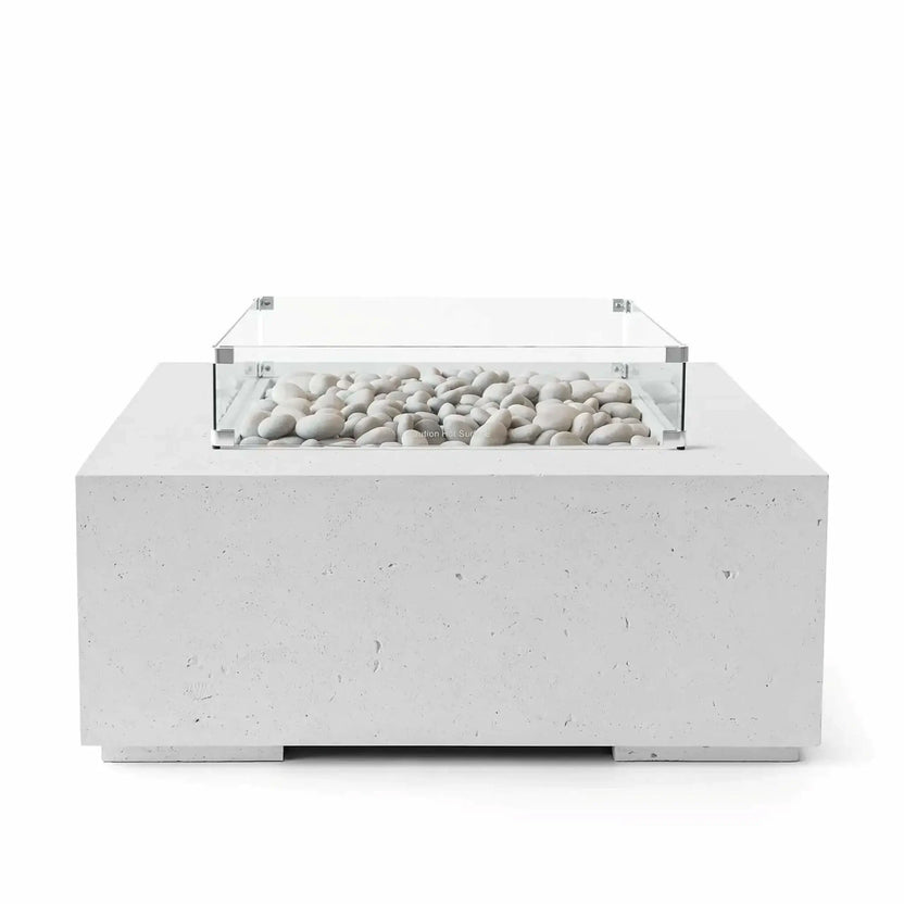 HPC Fire Hearth Products Controls Dekko GFRC Concrete Alea 40 x 40 Fire Pit in Ash finish featuring smooth ivory fire stones within a rectangular burner area. The modern square outdoor fire pit is constructed from durable GFRC concrete and includes a clear tempered glass wind guard surrounding the burner. Studio product image highlighting the contemporary concrete texture, clean lines, and premium outdoor fire feature design.
