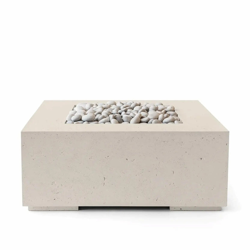 HPC Fire Hearth Products Controls Dekko GFRC Concrete Alea 40 x 40 Fire Pit in Clay finish with ivory fire stones. The square outdoor fire pit features a warm beige GFRC concrete body and a recessed burner opening filled with smooth white decorative stones. Its contemporary design, neutral clay color, and durable construction make it a versatile centerpiece for patios, outdoor lounges, and backyard entertaining areas.