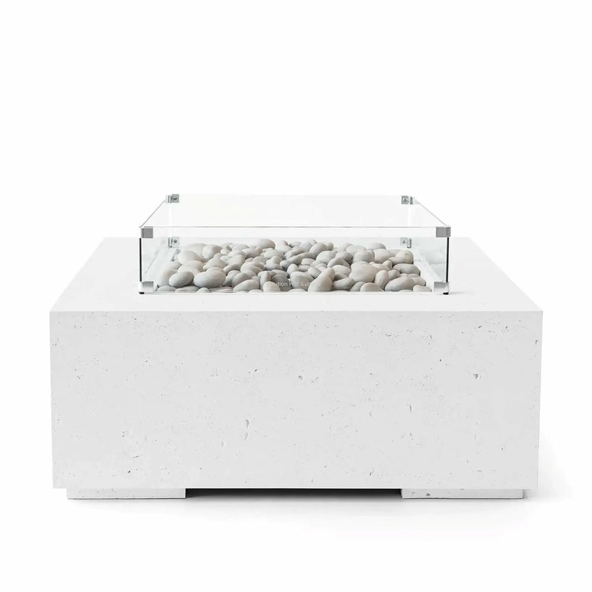 HPC Fire Hearth Products Controls Dekko GFRC Concrete Alea 40 x 40 Fire Pit in Natural finish featuring ivory fire stones arranged within the burner enclosure. The square concrete fire pit includes a clear tempered glass wind guard and subtle concrete texture that enhances its modern outdoor aesthetic. Studio image emphasizing the neutral natural finish, premium construction, and decorative stone media.