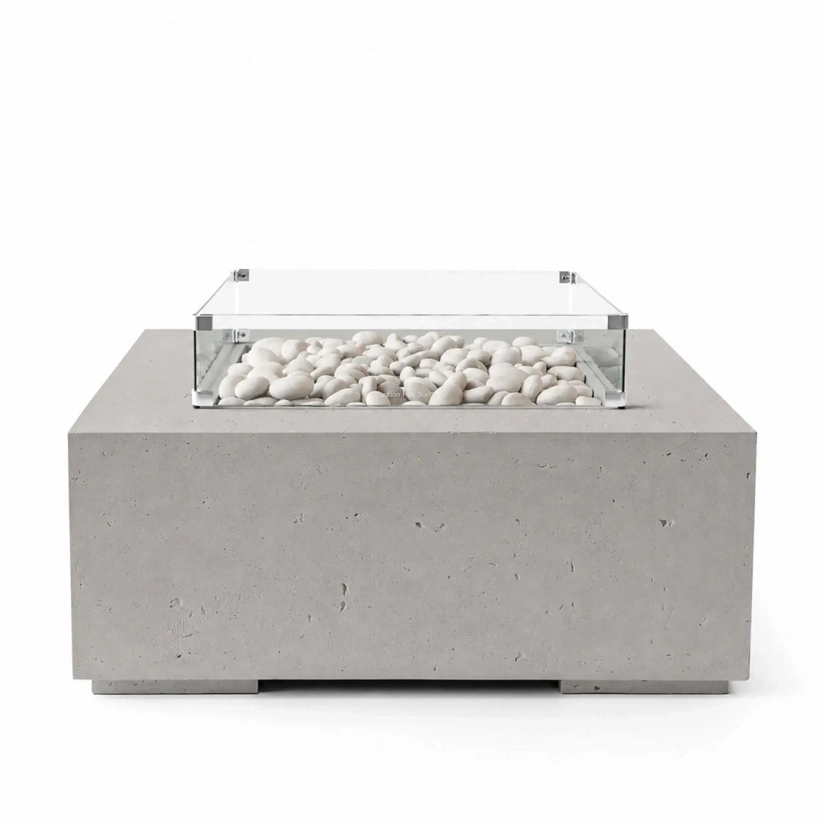 HPC Fire Hearth Products Controls Dekko GFRC Concrete Alea 40 x 40 Fire Pit in Sandstone finish with ivory fire stones filling the recessed burner area. The warm beige concrete body is paired with a clear tempered glass wind guard that frames the decorative media while preserving visibility. Product image highlighting the contemporary square design, durable GFRC construction, and upscale outdoor living appeal.