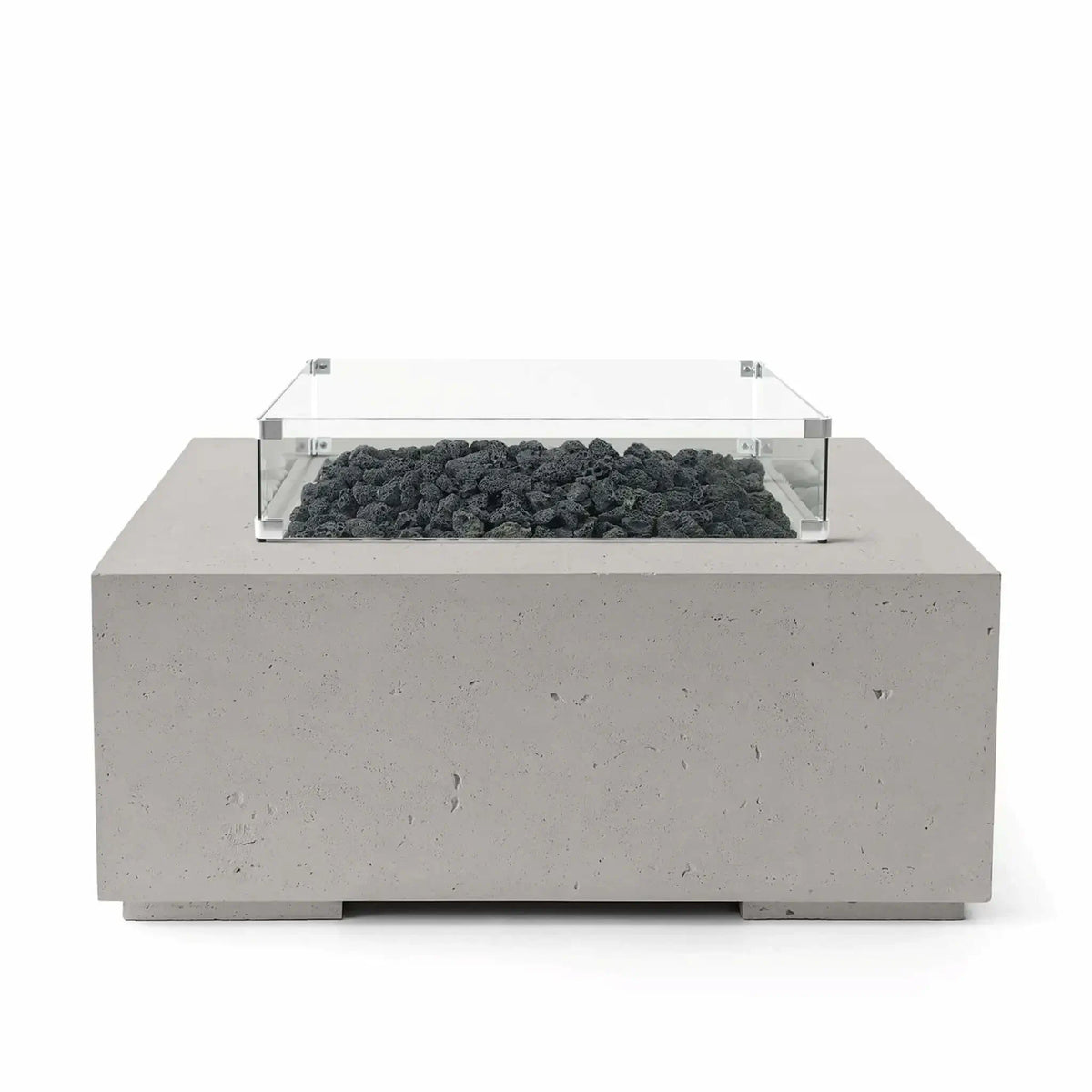 HPC Fire Hearth Products Controls Dekko GFRC Concrete Alea 40 x 40 Fire Pit finished in Sandstone with black lava rock fire media. The square outdoor fire pit features a textured GFRC concrete base and a clear tempered glass wind guard that surrounds the burner area. Professional studio image emphasizing the contrast between the warm sandstone finish and rugged volcanic rock for modern patio installations.