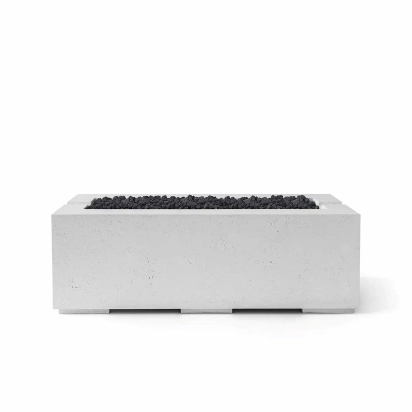 HPC Fire & Hearth Products Controls Dekko GFRC Concrete Avera 48 x 26 Fire Pit in Ash finish with black Lava Rock media. The modern rectangular GFRC concrete fire pit features a linear burner opening filled with natural volcanic lava rock, creating a striking contrast against the light gray concrete body. Shown in a studio product image, this Avera fire pit is ideal for upscale outdoor entertainment and contemporary landscape designs.