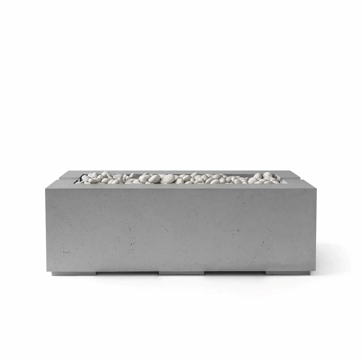 HPC Fire & Hearth Products Controls Dekko GFRC Concrete Avera 48 x 26 Fire Pit in Charcoal finish featuring decorative Ivory Stone media. The dark gray concrete body highlights the clean rectangular silhouette and linear burner opening filled with smooth white stones. Presented on a white background, this contemporary Avera fire pit offers a bold modern aesthetic for luxury outdoor living environments and backyard entertaining areas.