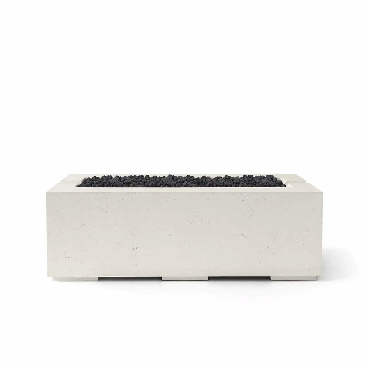 HPC Fire & Hearth Products Controls Dekko GFRC Concrete Avera 48 x 26 Fire Pit in Limestone finish with black Lava Rock media. The warm-toned GFRC concrete body contrasts beautifully with the rugged volcanic rock filling the linear burner opening. Shown in a studio product image on a white background, this modern Avera fire pit combines durable construction, contemporary styling, and premium outdoor performance for upscale residential and commercial spaces.