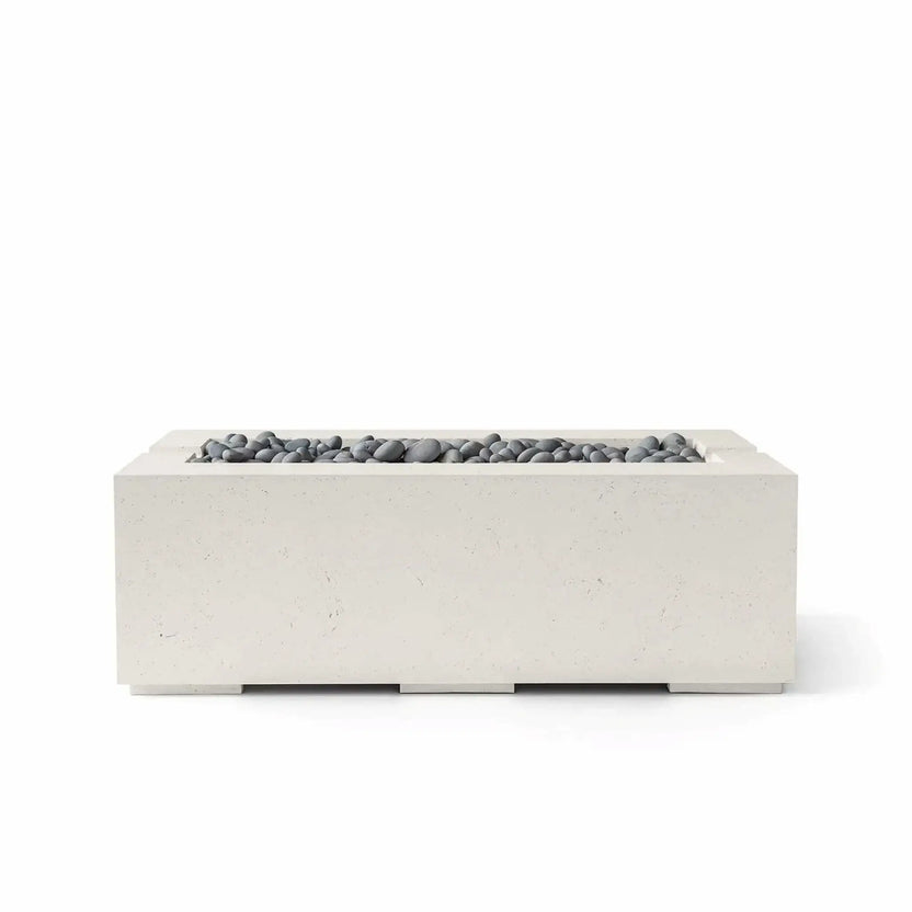 HPC Fire & Hearth Products Controls Dekko GFRC Concrete Avera 48 x 26 Fire Pit in Limestone finish featuring Slate Stone media. This rectangular GFRC concrete fire pit showcases a soft limestone-toned exterior paired with smooth gray slate stones arranged across the linear burner opening. Displayed on a clean white background, the Avera fire pit highlights contemporary outdoor design, durable construction, and a refined neutral color palette ideal for patios, pool decks, and luxury outdoor living spaces.
