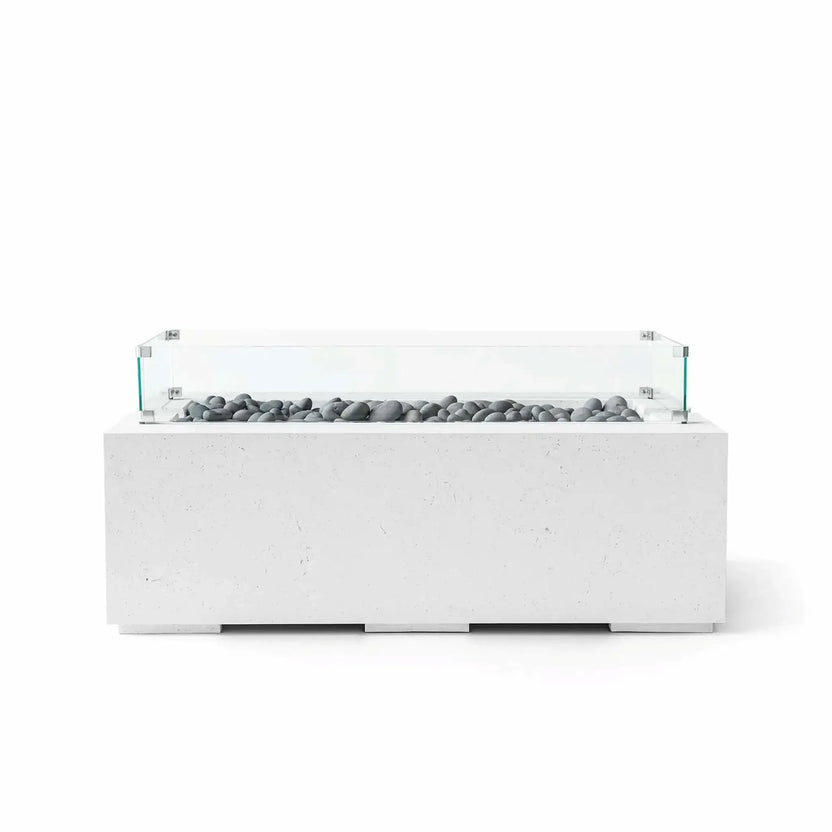 HPC Fire & Hearth Products Dekko GFRC Concrete Avera 48 x 26 Fire Pit Natural Slate Stone Tempered Glass Wind Guard featuring smooth gray slate stone fire media and a transparent tempered glass flame barrier. The natural-colored GFRC concrete body highlights subtle texture details and clean lines, creating a sophisticated fire table designed to complement modern outdoor furniture and landscape designs.