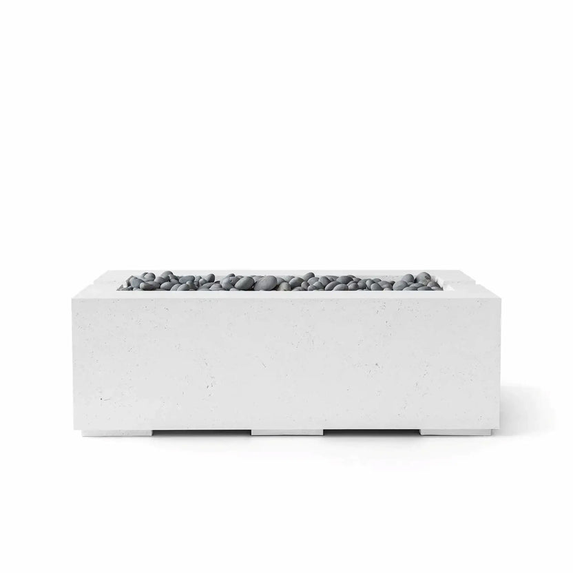 HPC Fire & Hearth Products Controls Dekko GFRC Concrete Avera 48 x 26 Fire Pit in Natural finish with Slate Stone media. The rectangular fire pit features a clean-lined GFRC concrete body in a soft gray tone complemented by smooth gray slate stones arranged within the recessed linear burner opening. Displayed on a white background, the Avera fire pit offers a balanced modern aesthetic designed for contemporary patios, poolside environments, and luxury outdoor living areas.
