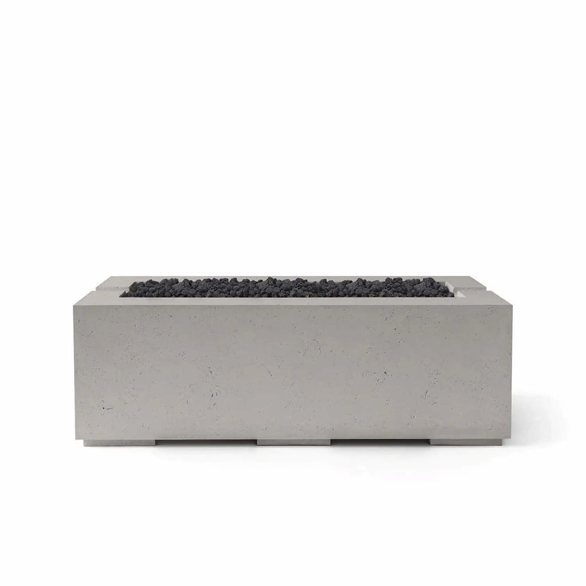 HPC Fire & Hearth Products Controls Dekko GFRC Concrete Avera 48 x 26 Fire Pit in Sandstone finish with Lava Rock media. The warm sandstone-toned rectangular concrete fire pit is contrasted by dark black lava rock filling the recessed burner area, creating a bold contemporary appearance. Displayed against a white background, this Avera fire pit highlights the combination of premium GFRC concrete construction, modern outdoor design, and versatile fire media options for luxury patio spaces.