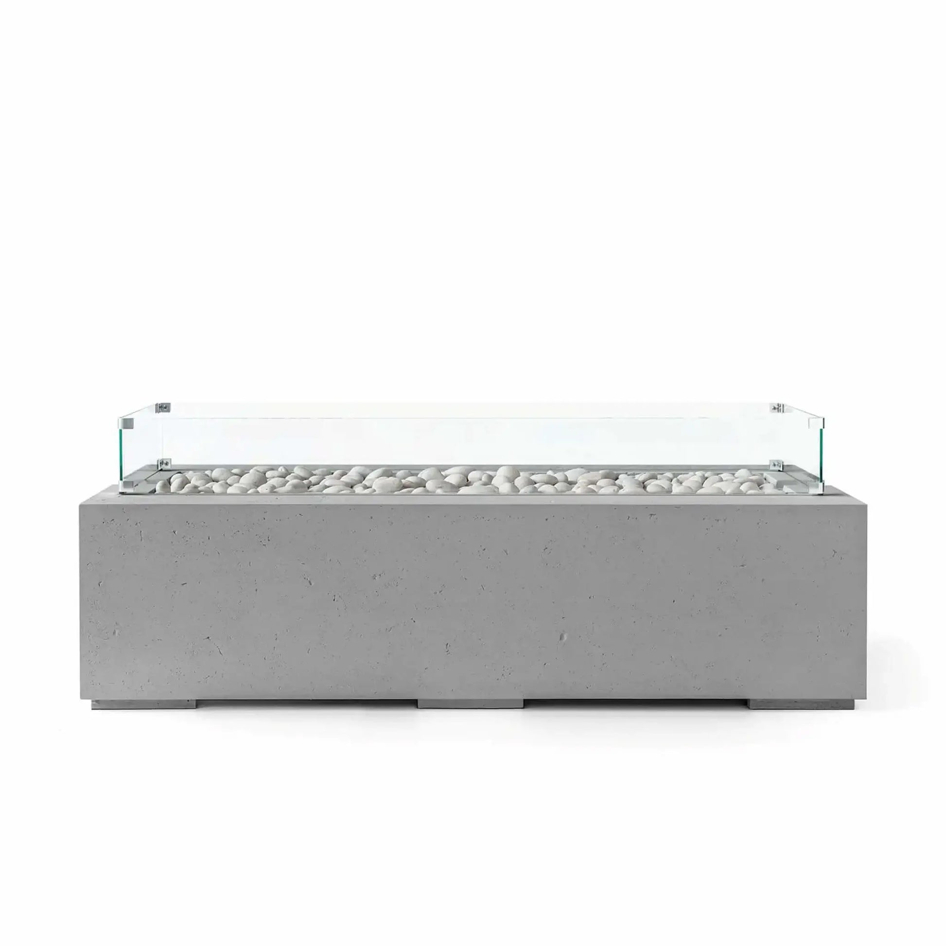 HPC Fire Hearth Products Controls Dekko GFRC Concrete Avera 60 x 26 Fire Pit in Charcoal finish with ivory fire stones and a tempered glass wind guard. The dark gray rectangular concrete fire pit highlights a clean linear burner opening, durable GFRC construction, and contemporary minimalist styling that enhances modern outdoor living areas, patios, and residential landscape designs.