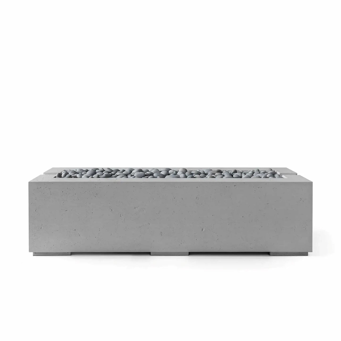 Dekko GFRC Concrete Avera 60 x 26 Fire Pit by HPC Fire Hearth Products Controls featuring a Charcoal finish and Slate Stone burner media. The elongated rectangular fire feature combines a textured concrete exterior with decorative gray stones, creating a sophisticated focal point for modern patios, outdoor lounges, and residential landscape designs.