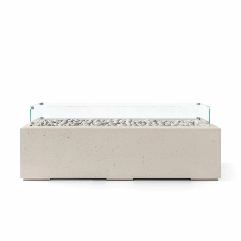 HPC Fire Hearth Products Controls Dekko GFRC Concrete Avera 60 x 26 Fire Pit in warm Clay finish with smooth ivory fire stones and a tempered glass wind guard. The rectangular outdoor fire pit showcases durable GFRC concrete construction, a contemporary low-profile silhouette, and a linear burner design that complements modern patios, courtyards, and outdoor gathering spaces.