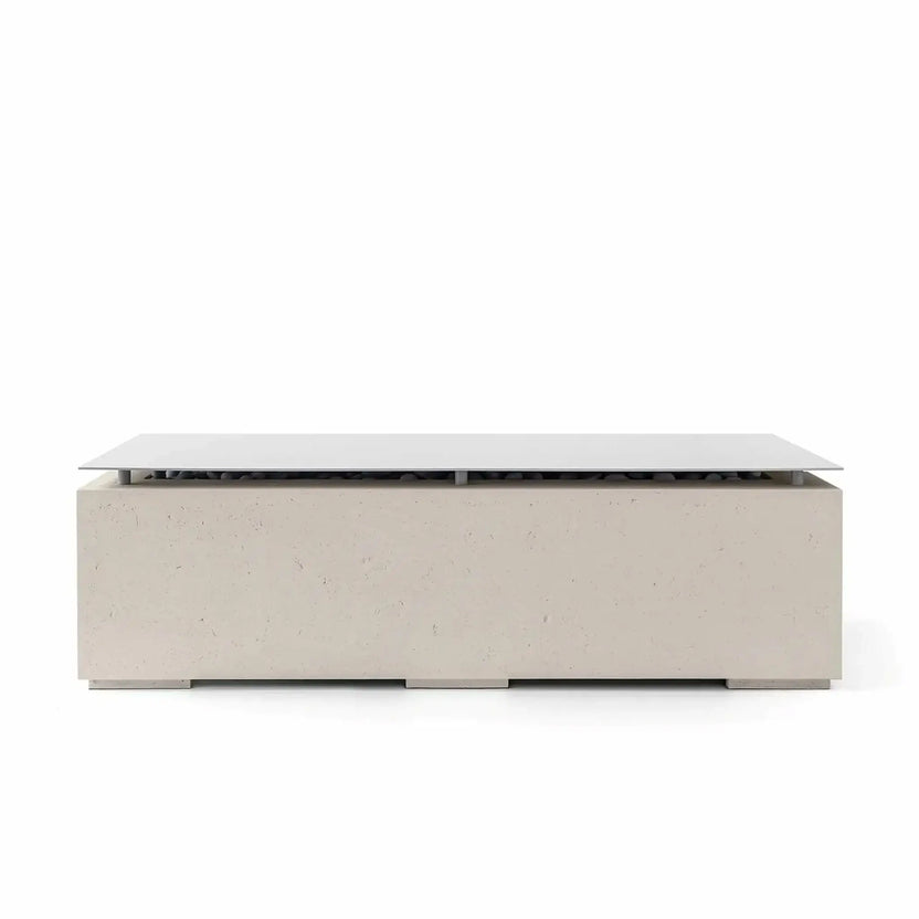 Studio product image of the HPC Fire Hearth Products Controls Dekko GFRC Concrete Avera 60 x 26 Fire Pit in a warm Clay finish with a stainless steel table top lid covering the burner area. The rectangular GFRC concrete fire pit features subtle surface texture, modern low-profile proportions, decorative fire media beneath the lid, and a refined outdoor furniture-inspired appearance.