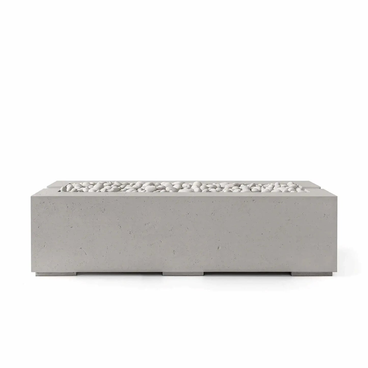 Studio product image of the HPC Fire Hearth Products Controls Dekko GFRC Concrete Avera 60 x 26 Fire Pit in Sandstone finish with Ivory Stone media. The elongated rectangular fire pit features clean geometric lines, durable GFRC concrete construction, and smooth white decorative stones that enhance its warm neutral color palette, making it an elegant addition to modern outdoor entertaining areas.