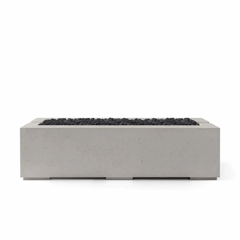 HPC Fire Hearth Products Controls Dekko GFRC Concrete Avera 60 x 26 Fire Pit featuring a Sandstone finish paired with black Lava Rock media. The light-toned concrete body contrasts beautifully with the rugged volcanic rock, highlighting the fire pit’s contemporary rectangular design, recessed burner area, and premium GFRC construction for upscale outdoor patios and backyard gathering spaces.