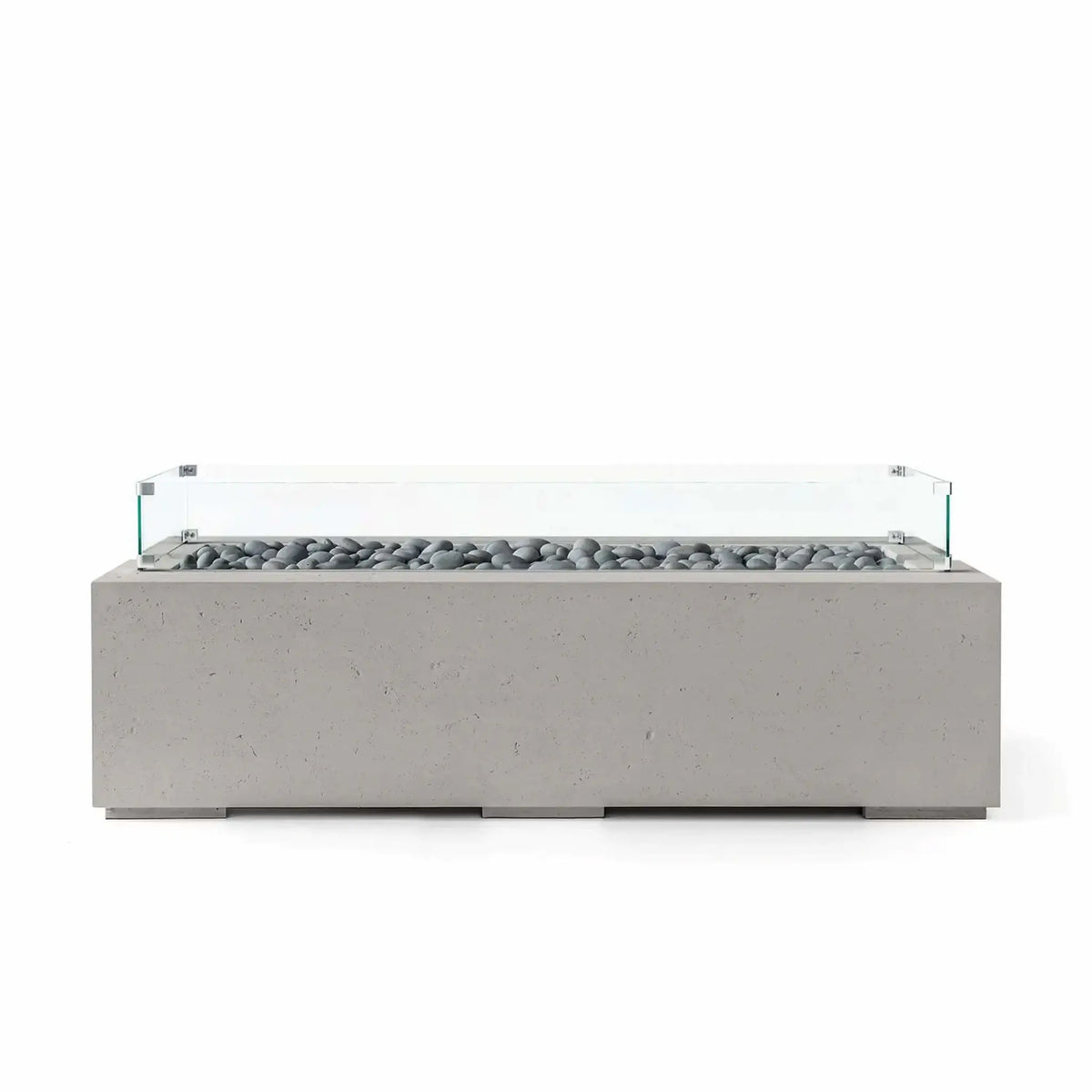 HPC Fire Hearth Products Controls Dekko GFRC Concrete Avera 60 x 26 Fire Pit in Sandstone finish with smooth slate stone media and a tempered glass wind guard. The rectangular fire pit table features a durable concrete-look GFRC body, low-profile modern design, and a linear burner enclosure that creates a refined centerpiece for contemporary outdoor living spaces.