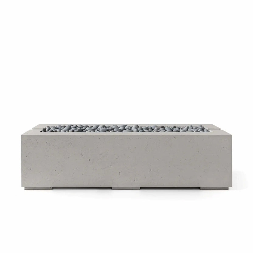 Front product view of the HPC Fire Hearth Products Controls Dekko GFRC Concrete Avera 60 x 26 Fire Pit in Sandstone finish with Slate Stone media. The rectangular outdoor fire feature showcases a warm concrete exterior, recessed burner tray, and smooth gray decorative stones that complement its minimalist design, creating a sophisticated focal point for contemporary outdoor living environments.