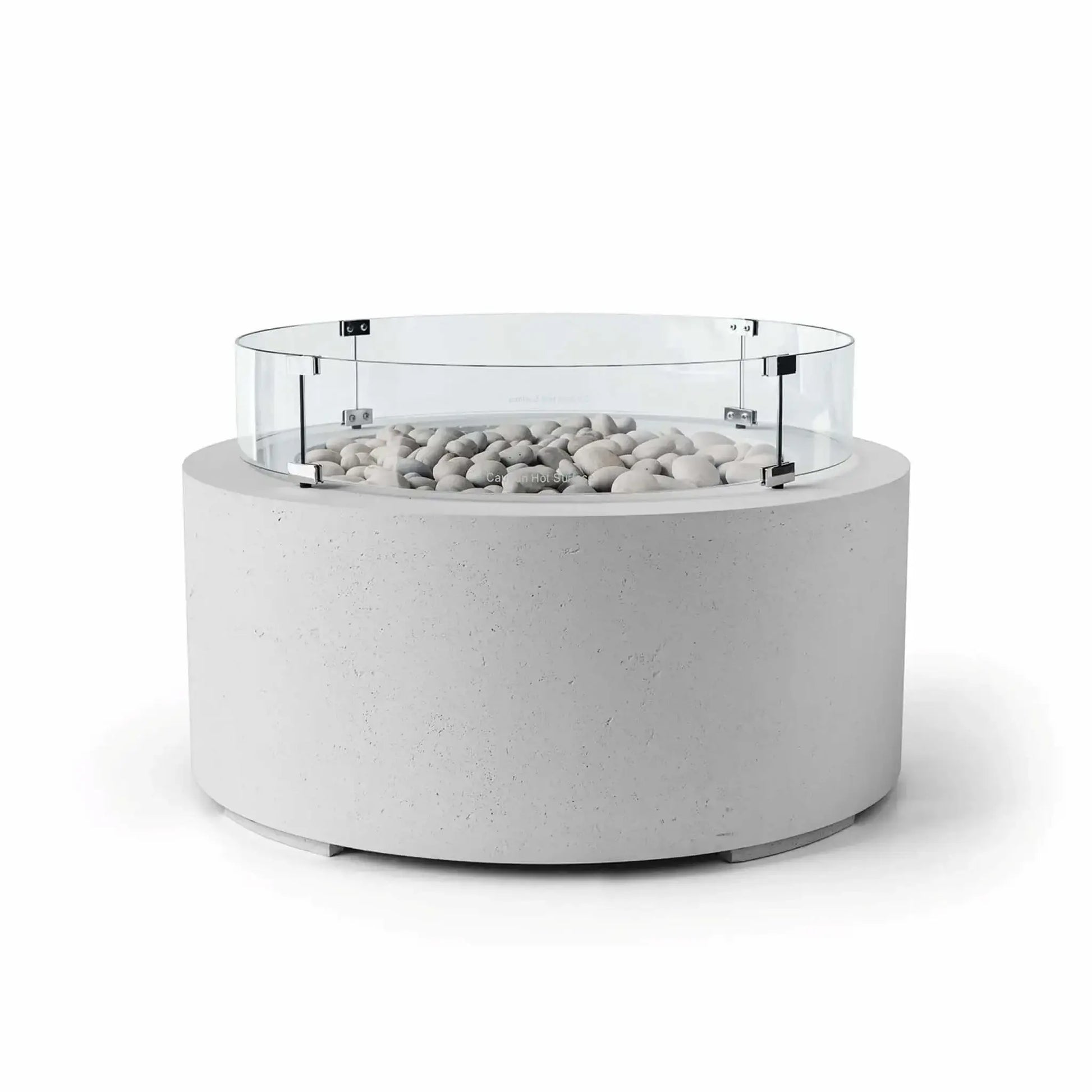 HPC Fire Hearth Products Controls Dekko GFRC Concrete Belmont Fire Pit in Ash finish featuring Ivory Stone media and a round Tempered Glass Wind Guard. The modern fire pit showcases a light gray concrete cylinder base, decorative ivory fire stones, and a clear glass windscreen secured with metal brackets. Displayed on a white background, this Belmont Fire Pit combines contemporary outdoor design, wind protection, and durable GFRC concrete construction.
