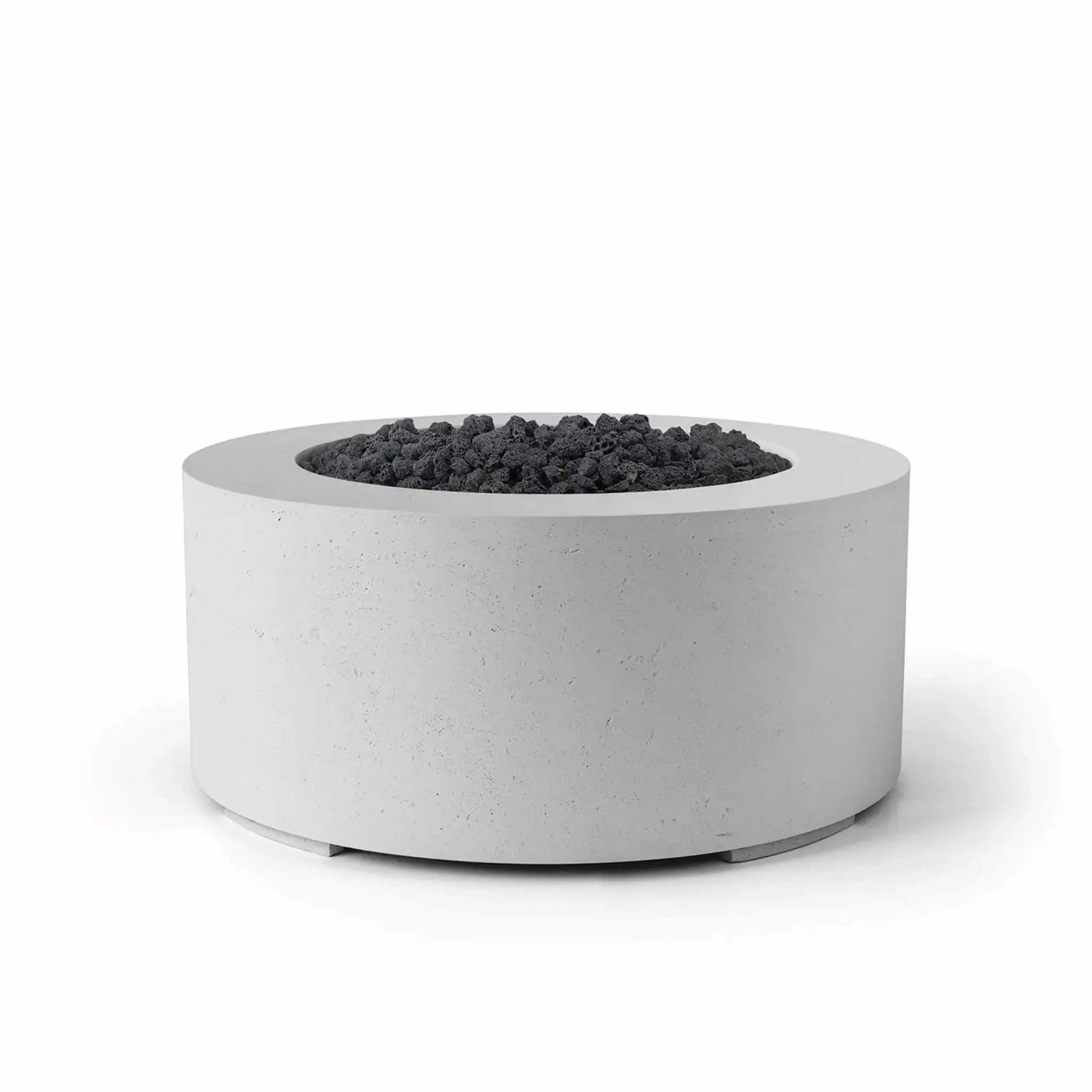 HPC Fire Hearth Products Controls Dekko GFRC Concrete Belmont Fire Pit in Ash finish with black lava rock fire media. This round 36-inch outdoor fire pit features a durable GFRC concrete construction, recessed burner pan, and smooth cylindrical profile. The contrast between the light ash concrete finish and dark lava rock creates a modern, upscale look ideal for patios, backyard gathering areas, resorts, and outdoor entertainment spaces.