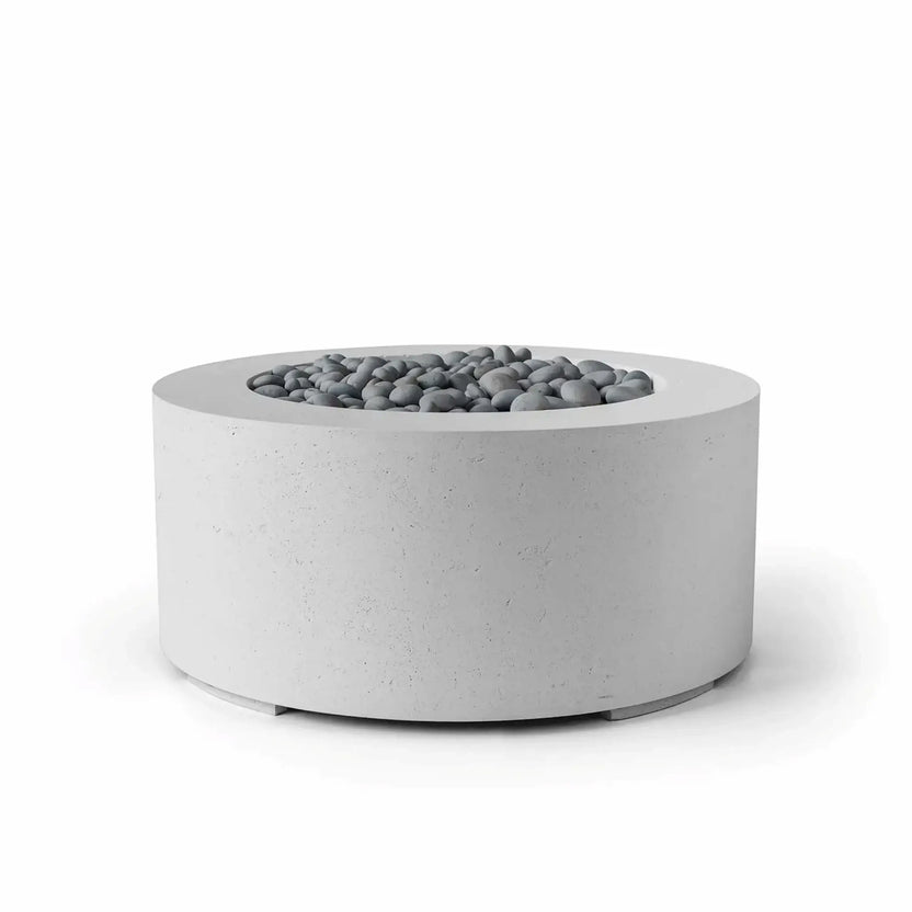 HPC Fire Hearth Products Controls Dekko GFRC Concrete Belmont Fire Pit in Ash finish showcasing decorative slate stone media within the recessed burner opening. The round GFRC concrete fire pit features a textured light-gray finish, broad top ledge, and contemporary low-profile silhouette. Designed for outdoor living environments, this Belmont fire pit combines modern architectural styling with durable materials for residential and commercial installations.