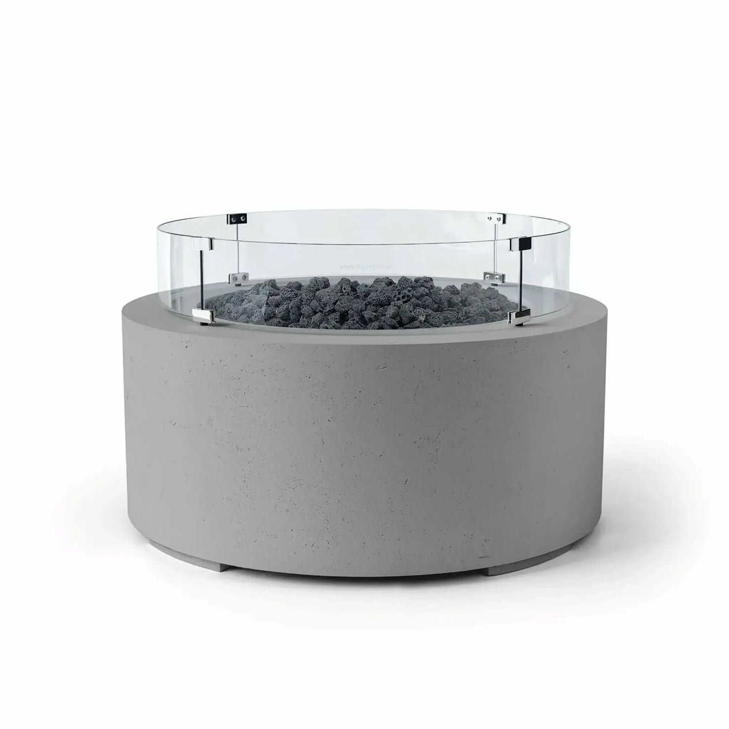 HPC Fire Hearth Products Controls Dekko GFRC Concrete Belmont Fire Pit in Charcoal finish with Lava Rock media and a Tempered Glass Wind Guard. The round GFRC concrete fire pit features a rich charcoal-gray exterior, rugged black lava rock fire media, and a clear glass windscreen secured with metal mounting brackets. This Belmont Fire Pit is designed to enhance outdoor entertaining areas while providing contemporary style and added flame protection.