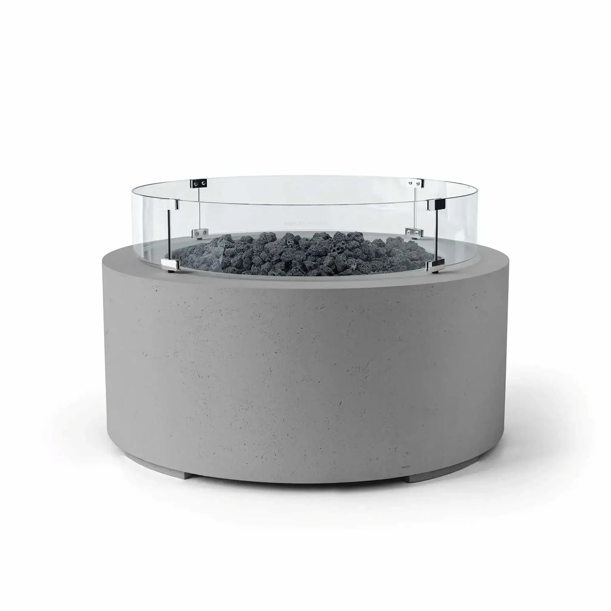 HPC Fire Hearth Products Controls Dekko GFRC Concrete Belmont Fire Pit in Charcoal finish with Lava Rock media and a Tempered Glass Wind Guard. The round GFRC concrete fire pit features a rich charcoal-gray exterior, rugged black lava rock fire media, and a clear glass windscreen secured with metal mounting brackets. This Belmont Fire Pit is designed to enhance outdoor entertaining areas while providing contemporary style and added flame protection.