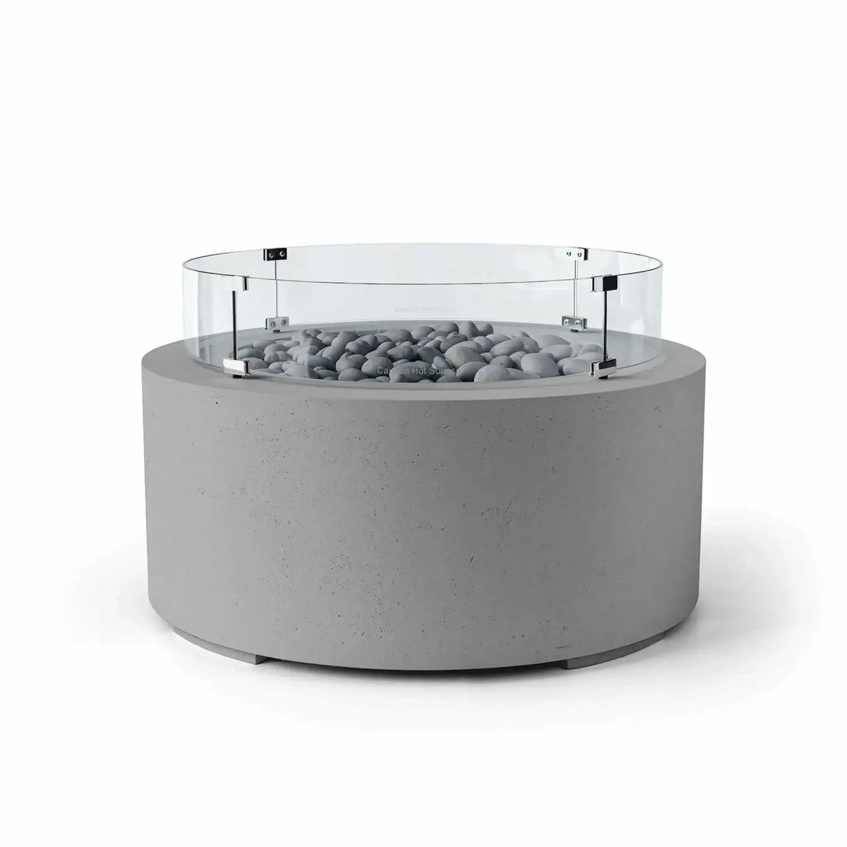 HPC Fire Hearth Products Controls Dekko GFRC Concrete Belmont Fire Pit in Charcoal finish featuring Slate Stone media and a Tempered Glass Wind Guard. This modern outdoor fire pit combines a cylindrical charcoal concrete base with polished gray slate stones and a circular clear glass windscreen around the burner area. The Belmont Fire Pit offers an elegant architectural look while helping protect flames in open-air environments.